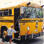 kids getting on school bus