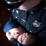 policeman holding baby